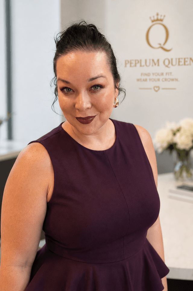Aubrey Young, founder of The Peplum Queen, wearing a plum peplum dress